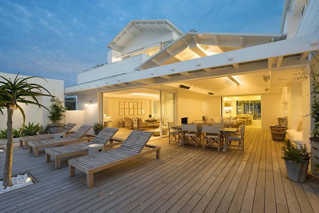 Bright contemporary outdoor deck and patio area with lounge chairs completed by Deck Solution Corporation