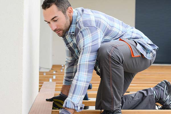 Working man installing a flooring 